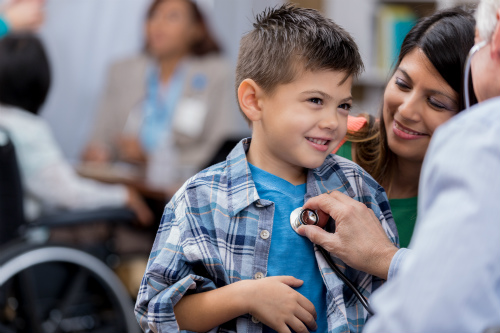 Child being checked out by doctor