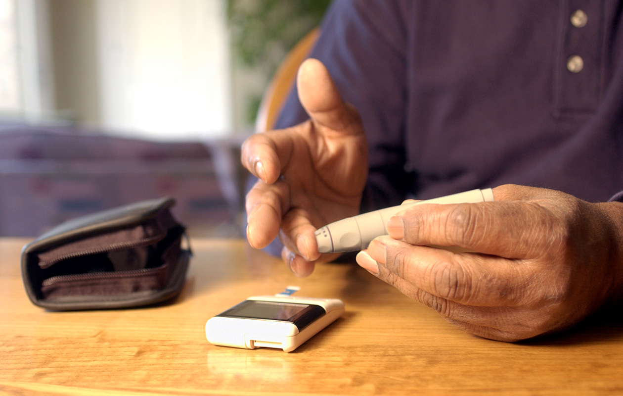 Man taking blood glucose