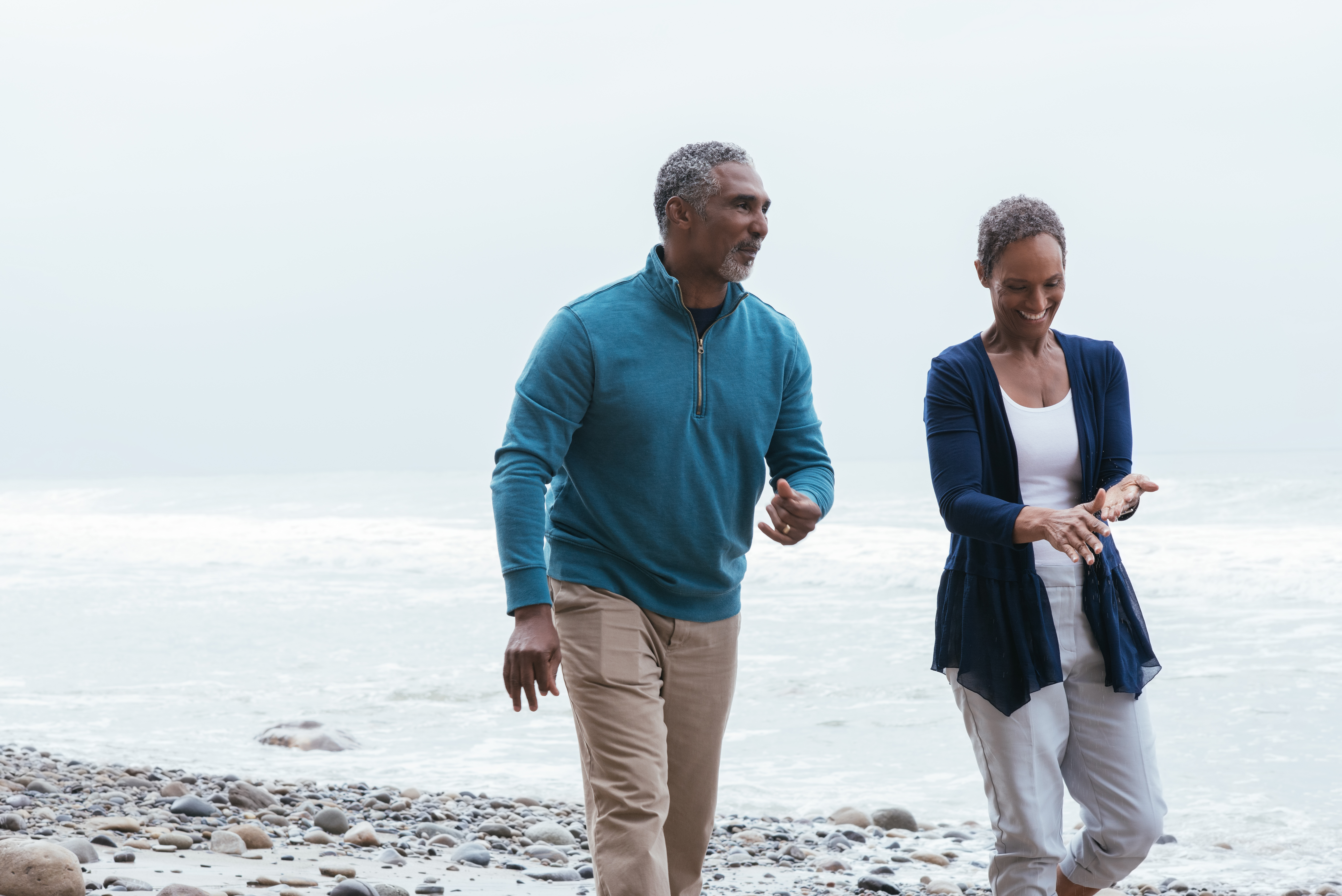 Older couple walking on beach