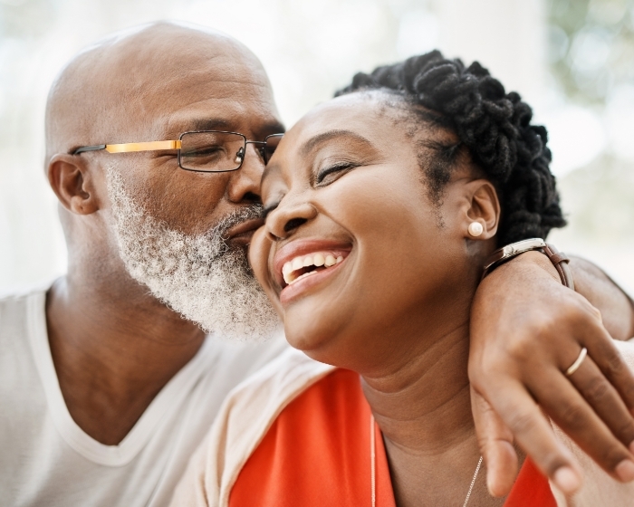 African american man kissing wife on cheek