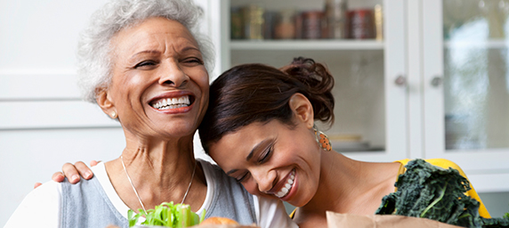 Mature mother and daughter with fresh groceries