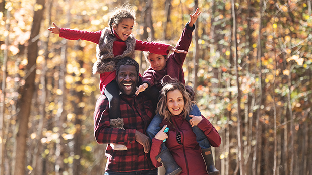 Mixed race family picking pumpkins at the farm, during autumn, Quebec, Canada