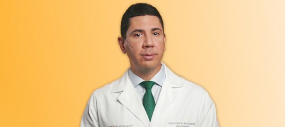 portrait of doctor in white coat on yellow background