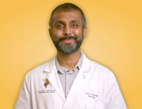 portrait of doctor in white coat on yellow background