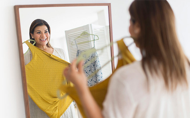 Woman looking at herself in the mirror