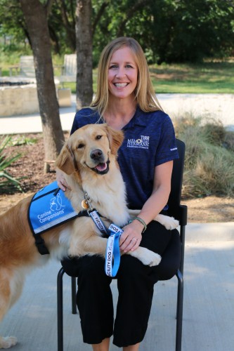 TIRR Memorial Hermann facility dog, Annie, poses with her TIRR team mate. 