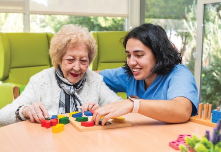 TIRR Memorial Hermann therapist and patient work side-by-side.