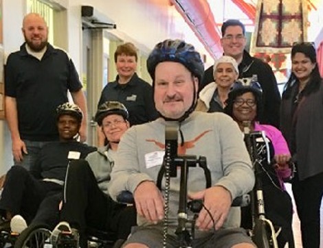 TIRR Memorial Hermann patients ride different mobility devices through the hallways.