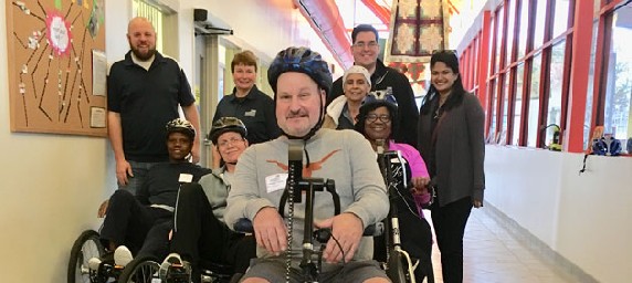 TIRR Memorial Hermann patients ride different mobility devices through the hallways.