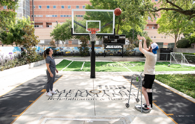 A TIRR Memorial Hermann patient shoots basketball at Sports Park