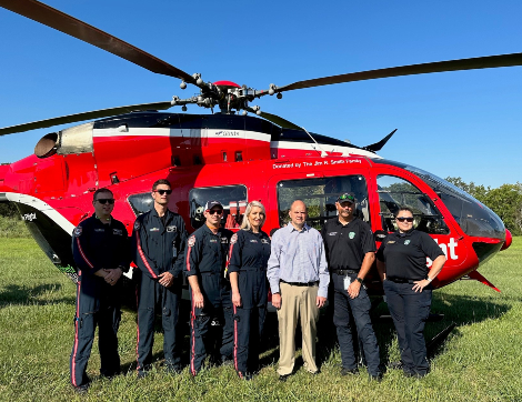 Trauma survivor, Eric, stands with the Life Flight team.