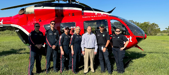 Trauma survivor, Eric, stands with the Life Flight team.