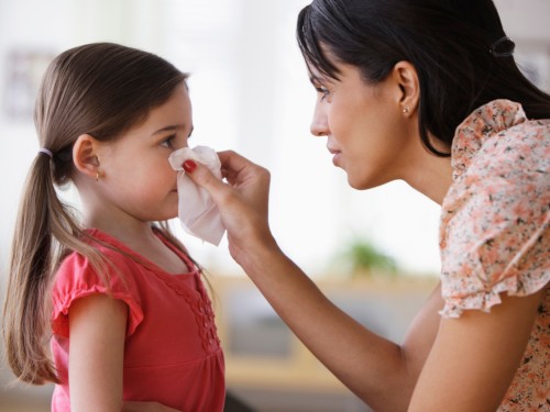 Mom blowing kid's nose