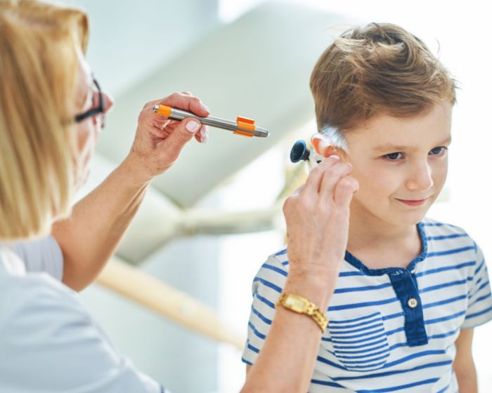 doctor checking child's ear